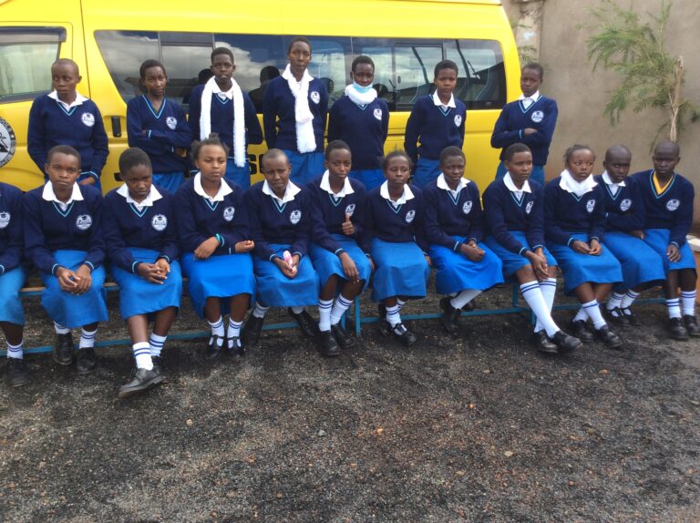 The new students take a picture in front of the Juanita School Van.